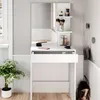 A white vanity table with a mirror and various makeup items. Podgląd zdjęcia produktu
