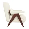 A side view of a cream-colored armchair with dark brown wooden legs. Náhled obrázku produktu