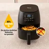 A black air fryer is shown on a countertop, with a graphic overlay indicating reduced oil usage and text promoting healthier meals. Produktbild-Vorschau