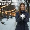 A woman in a snowy park holding snow in her hands. Produktbild-Vorschau