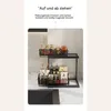 A two-tiered kitchen organizer shelf holding various bottles and jars. Voir les images du produit