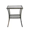 A single rattan side table with a glass top and a lower shelf, presented on a white background. Podgląd zdjęcia produktu