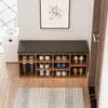 A shoe bench with shoes stored in it, an air purifier, and a picture on the wall. Anteprima dell’immagine prodotto