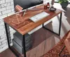 A wooden desk with a computer, keyboard, and lamp in a home office setting. Produktbild-Vorschau