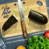 A cutting board with zucchini, a knife, and vegetables, along with text highlighting product features. Produktbild-Vorschau