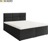 A dark grey boxspring bed with a white mattress and topper, shown from a three-quarter angle against a white background. Náhled obrázku produktu