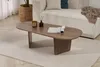 A modern living room setting with a couch, coffee table, and rug. Produktbild-Vorschau