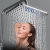 A woman is showering under a large square shower head. Podgląd zdjęcia produktu