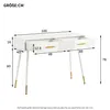 A white dressing table with gold accents and metal legs, shown with dimensions indicated by measurement lines and numbers. Podgląd zdjęcia produktu