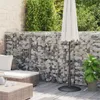 A patio area with a gabion wall, outdoor furniture, and an umbrella. Produktbild-Vorschau