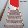 A set of stairs covered with protective fleece, with a bucket and paint roller at the top. Náhľad obrázku produktu