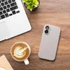 A top-down view of a desk with a laptop, a cup of coffee with latte art, and a smartphone with a case. Produktbild-Vorschau