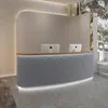 A modern reception desk with two computer monitors in a well-lit, contemporary interior. Produktbild-Vorschau