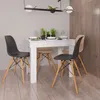 A dining table with chairs in a room. Produktbild-Vorschau