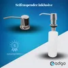 Two soap dispensers are shown against a blue and white gradient background. One is a chrome dispenser with a spout, and the other is a chrome dispenser with a white bottle attached. Anteprima dell’immagine prodotto