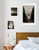 A bedroom scene with framed pictures on the wall above a bed. Produktbild-Vorschau