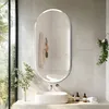 A modern bathroom with a sink, mirror, and plants. Podgląd zdjęcia produktu