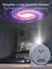 A projector lamp projecting a galaxy onto a bedroom ceiling, with the lamp itself in the foreground. Náhled obrázku produktu