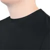 Close-up of a person's neck and shoulder wearing a black t-shirt. Náhľad obrázku produktu