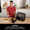A man is preparing food in a kitchen, with an air fryer and a bowl of fries visible. Produktbild-Vorschau