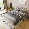 A bedroom scene featuring a tufted bed with open storage drawers. Náhľad obrázku produktu