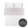 A neatly made bed with white sheets, two white pillows, and a light gray duvet cover. A dark gray circular overlay with text is in the bottom right corner. Voir les images du produit
