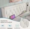 A close-up view of a white upholstered headboard with tufted buttons, featuring two tablets and a USB-C charging port. Voir les images du produit