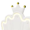 A close-up view of a white upholstered headboard with a crown design and LED lighting. Náhled obrázku produktu