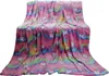 A fluffy blanket with a unicorn and rainbow pattern is draped over a surface. Anteprima dell’immagine prodotto