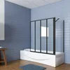 A modern bathroom with blue tiled walls, a white bathtub with a black framed glass shower screen, and a wooden stool with towels. Produktbild-Vorschau