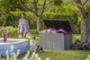 A woman and a child are playing with water guns near an inflatable pool, while a dog sits nearby. A storage box is open and filled with pool toys. Produktbild-Vorschau