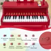 A red toy piano keyboard with various features listed below it. Podgląd zdjęcia produktu