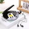 A portable CD player with headphones is placed on top of a book. A wooden calendar is in the background. Podgląd zdjęcia produktu