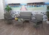 A poly-rattan furniture set is displayed on a wooden deck with a tropical beach mural in the background. Produktbild-Vorschau
