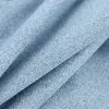 A close-up view of blue fabric with a herringbone pattern. Produktbild-Vorschau