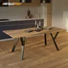 A wooden dining table with black metal legs in a modern kitchen setting. Náhled obrázku produktu