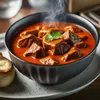 A close-up shot of a bowl of goulash with a piece of bread on the side. Produktbild-Vorschau