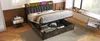 A modern bedroom with a bed that has storage underneath, a nightstand, and a window with a view. Voir les images du produit