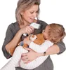 A woman is holding a baby and a teddy bear, and is using a thermometer on the baby. Produktbild-Vorschau