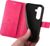 A hand is holding a pink flip phone case open, revealing the black interior where a phone would be placed. Produktbild-Vorschau