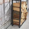 A firewood rack filled with logs next to a textured wall. Podgląd zdjęcia produktu