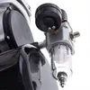 A close-up view of an airbrush compressor's pressure regulator and filter. Podgląd zdjęcia produktu