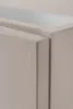A close-up view of the corner of a beige cabinet, showing the join between two panels. Produktbild-Vorschau