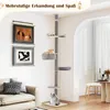 A cat tree is shown in a living room setting with a sofa and artwork on the wall. Produktbild-Vorschau