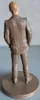 A figurine of a man in a pinstripe suit, viewed from the back, standing on a circular base. Produktbild-Vorschau
