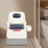 A portable toilet chair with a tissue dispenser attached, shown in a bathroom setting. Podgląd zdjęcia produktu