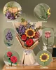 A 3D wooden puzzle bouquet with various flowers and a message card, displayed on a table. Produktbild-Vorschau
