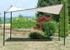 A beige canopy tent is set up in a garden with lush green bushes and trees in the background. Produktbild-Vorschau
