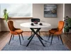 A dining table with chairs set up in a room with a window and artwork. Anteprima dell’immagine prodotto