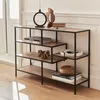 A modern, asymmetrical shelf unit made of metal and wood-look material, decorated with books and decorative items. Produktbild-Vorschau